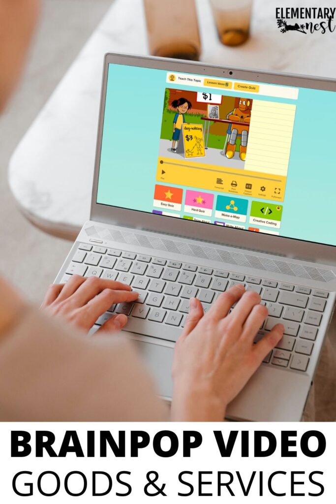 A teacher using a laptop to show a BrainPOP Jr. video lesson about goods and services