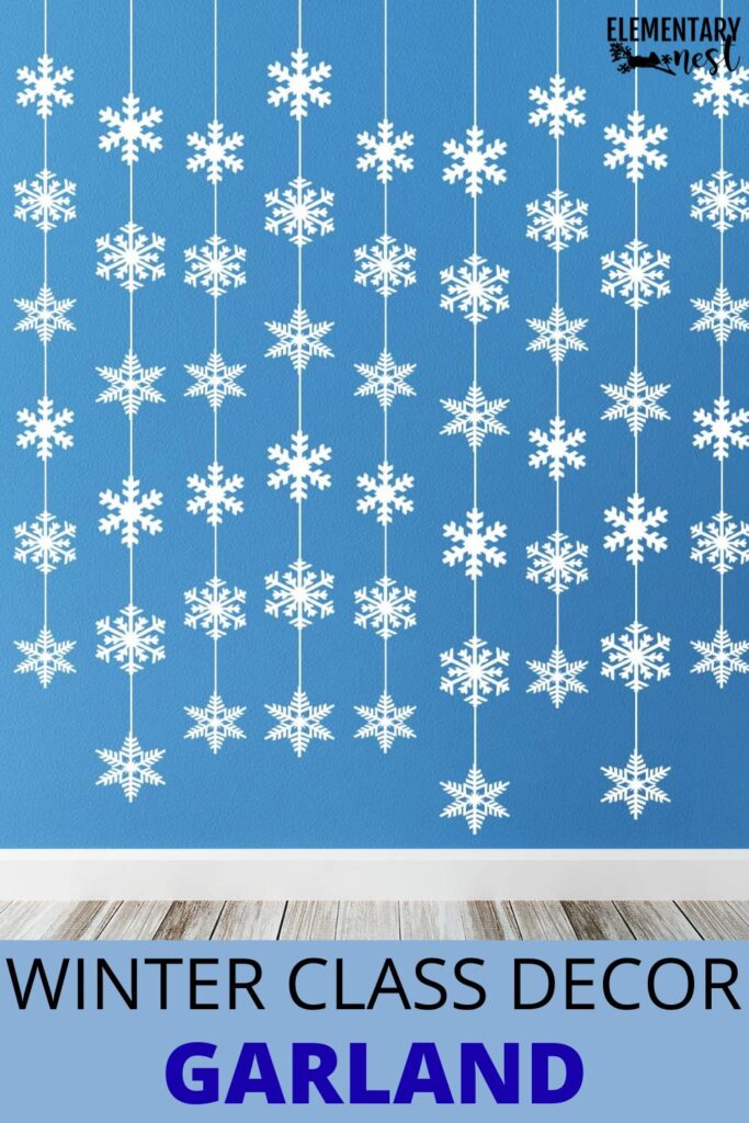 Hanging snowflake garland strands on a blue wall as classroom winter decor.